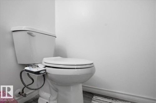 The bathroom features a white toilet - 5837 162A Avenue, Edmonton, AB - Indoor Photo Showing Bathroom