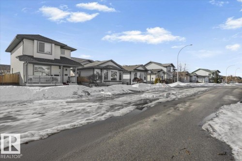 The property features a two-story exterior with light-colored siding and a dark roof - 5837 162A Avenue, Edmonton, AB - Outdoor