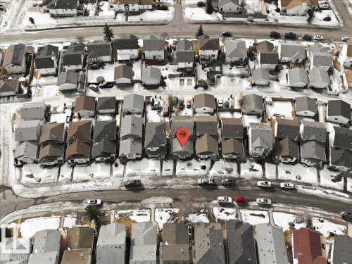 Aerial view of the property and its surrounding neighborhood, featuring residential homes with varied rooflines and a street with parked vehicles - 5837 162A Avenue, Edmonton, AB - Outdoor With View