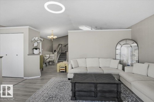 The living area features light-toned walls, crown molding, and a light-colored ceiling - 5837 162A Avenue, Edmonton, AB - Indoor Photo Showing Living Room