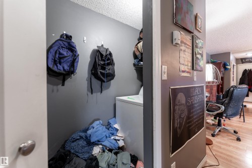 This utility space features a washer and a textured ceiling - 2 10737 116 Street, Edmonton, AB - Indoor Photo Showing Laundry Room
