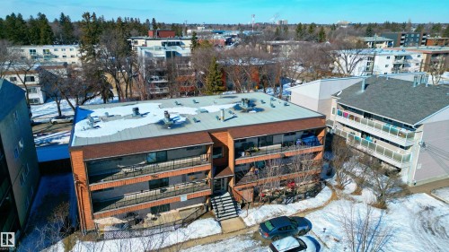 The property features a brick exterior with balconies and a flat roof - 2 10737 116 Street, Edmonton, AB - Outdoor