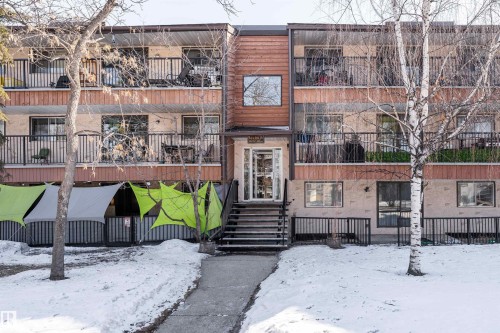 The building features a multi-level design with balconies on the upper floors, and a main entrance with stairs leading to a glass door - 2 10737 116 Street, Edmonton, AB - Outdoor