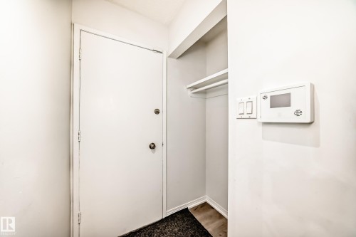 Entryway featuring a white door, a closet with shelving, and wall-mounted controls - 4312 43 Avenue, Leduc, AB - Indoor Photo Showing Other Room