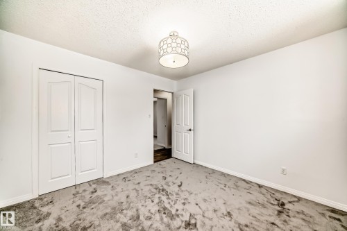 This room features white walls, a ceiling light fixture, and a white interior door - 4312 43 Avenue, Leduc, AB - Indoor Photo Showing Other Room