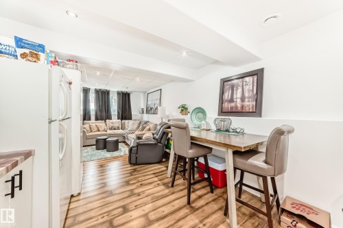 Open concept living space featuring wood flooring, a white refrigerator, and recessed lighting - 4312 43 Avenue, Leduc, AB - Indoor Photo Showing Dining Room