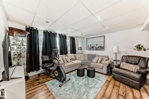 Living area featuring hard surface flooring, white walls, and recessed lighting - 4312 43 Avenue, Leduc, AB - Indoor Photo Showing Living Room