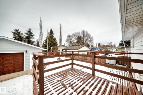 The property includes a wooden deck with a railing and an exterior finished with horizontal siding - 4312 43 Avenue, Leduc, AB - Outdoor With Deck Patio Veranda With Exterior