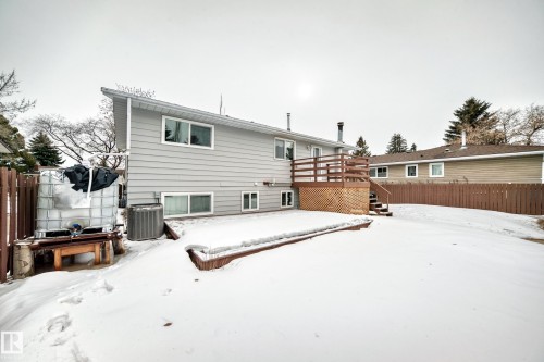 The property features a gray exterior with white window frames and a sloped roofline - 4312 43 Avenue, Leduc, AB - Outdoor With Exterior