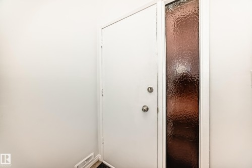Entryway featuring a white door with a side panel of textured, translucent glass - 4312 43 Avenue, Leduc, AB - Indoor Photo Showing Other Room