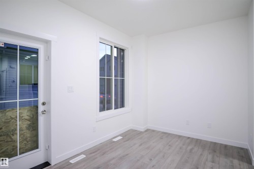 Empty room featuring light wood-style floors and baseboards - 53 7110 Keswick Common Sw, Edmonton, AB - Indoor Photo Showing Other Room