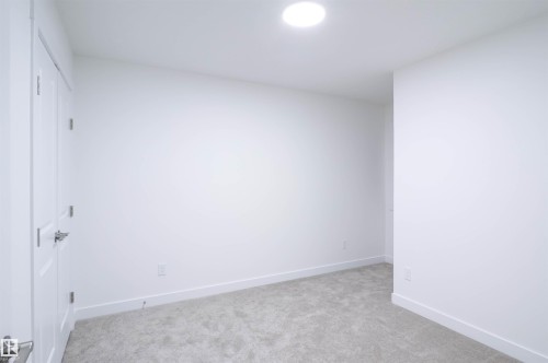 Unfurnished bedroom with light carpet and a closet - 53 7110 Keswick Common Sw, Edmonton, AB - Indoor Photo Showing Other Room