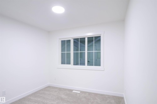 Empty room with baseboards and carpet floors - 53 7110 Keswick Common Sw, Edmonton, AB - Indoor Photo Showing Other Room