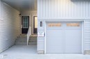 Entrance to property with a garage and a porch - 53 7110 Keswick Common Sw, Edmonton, AB  - Outdoor With Exterior 