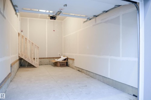 Garage featuring a garage door opener - 53 7110 Keswick Common Sw, Edmonton, AB - Indoor