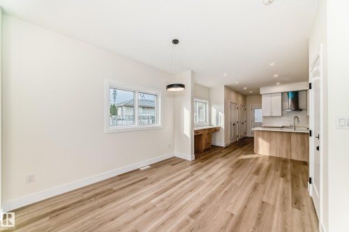 The property features an open-concept layout with light-toned flooring, white walls, and recessed lighting - 10718 149 Street Nw, Edmonton, AB - Indoor