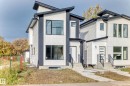 The property features a contemporary design with white siding, dark trim, and prominent windows - 10718 149 Street Nw, Edmonton, AB  - Outdoor With Facade 