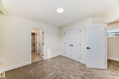 This room features plush carpeting and white walls, creating a bright and inviting atmosphere - 10718 149 Street Nw, Edmonton, AB - Indoor Photo Showing Other Room
