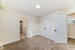 This room features plush carpeting and white walls, creating a bright and inviting atmosphere - 