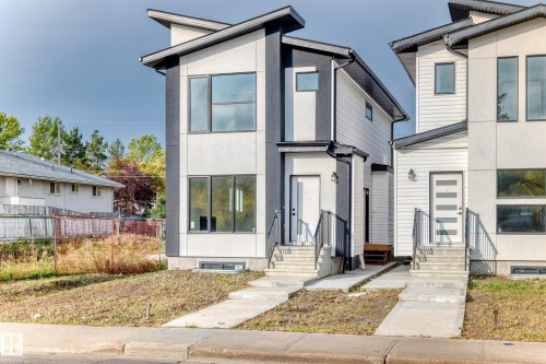 The property features a contemporary architectural style with a flat roofline and a combination of light and dark exterior finishes - 10718 149 Street Nw, Edmonton, AB - Outdoor With Facade