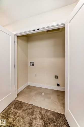 Dedicated utility closet with tile flooring, white baseboards, and essential hookups - 10718 149 Street Nw, Edmonton, AB - Indoor Photo Showing Other Room