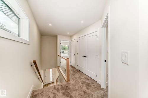 Hallway featuring light-colored walls, recessed lighting, and carpeted floors - 10718 149 Street Nw, Edmonton, AB - Indoor Photo Showing Other Room