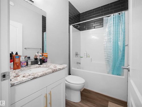The bathroom features a vanity with a light-colored countertop and a white sink - 138 804 Welsh Drive, Edmonton, AB - Indoor Photo Showing Bathroom