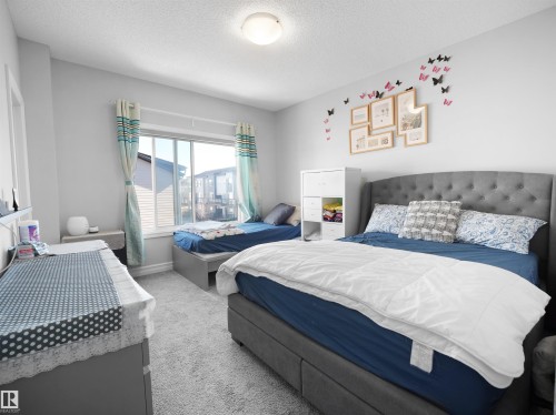 This room features light-colored walls and carpeted flooring - 138 804 Welsh Drive, Edmonton, AB - Indoor Photo Showing Bedroom