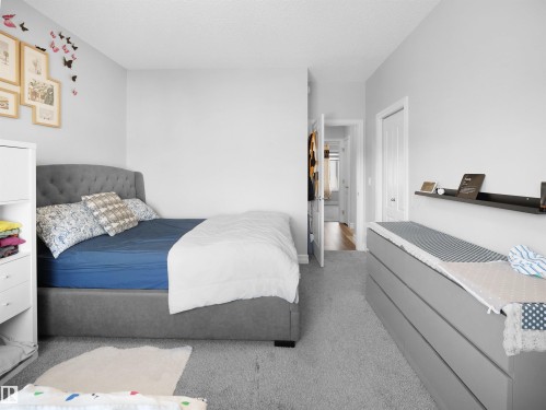 This room features light gray walls, plush gray carpeting, and a white ceiling - 138 804 Welsh Drive, Edmonton, AB - Indoor Photo Showing Bedroom