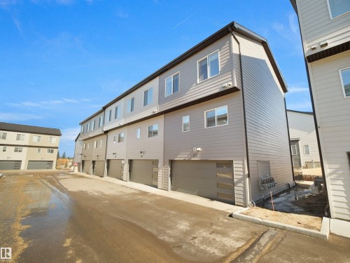 The property features a modern exterior with horizontal siding and multiple windows - 138 804 Welsh Drive, Edmonton, AB - Outdoor With Exterior