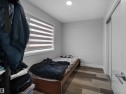 This room features light grey walls, a window with horizontal blinds, and wood-look plank flooring - 138 804 Welsh Drive, Edmonton, AB  - Indoor Photo Showing Bedroom 
