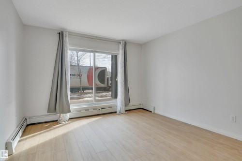 This space features light-toned flooring and white walls, creating a bright and open atmosphere - 108 1204 156 Street, Edmonton, AB - Indoor Photo Showing Other Room