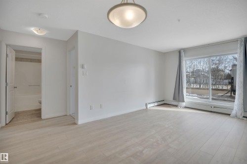 The property features light-toned flooring and white walls throughout - 108 1204 156 Street, Edmonton, AB - Indoor Photo Showing Other Room