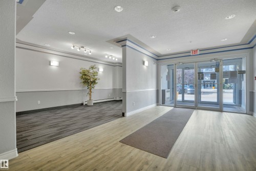 Entryway featuring light wood tone flooring, a carpeted area, and recessed ceiling lights - 108 1204 156 Street, Edmonton, AB - Indoor Photo Showing Other Room