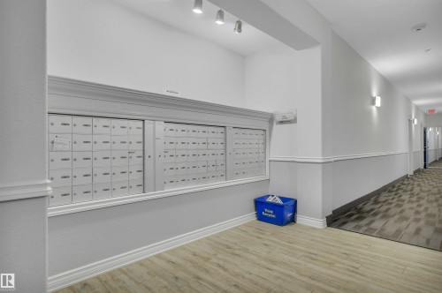 The property features a well-lit hallway with a large bank of mailboxes, offering convenient access - 108 1204 156 Street, Edmonton, AB - Indoor Photo Showing Other Room
