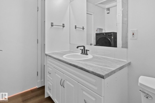 Bathroom vanity with a white countertop and a white sink - 116 11033 127 Street, Edmonton, AB - Indoor