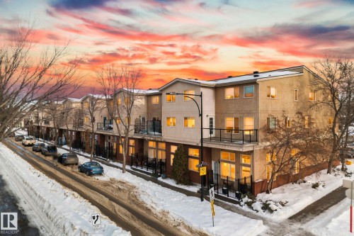 The property features a multi-story exterior with balconies and ground-floor patios - 116 11033 127 Street, Edmonton, AB - Outdoor