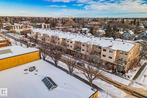 This property features multi-story residential buildings with balconies, situated along a street with bare trees - 116 11033 127 Street, Edmonton, AB - Outdoor With View