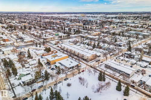 Aerial perspective showcasing the community's residential properties, roads, and trees - 116 11033 127 Street, Edmonton, AB - Outdoor With View