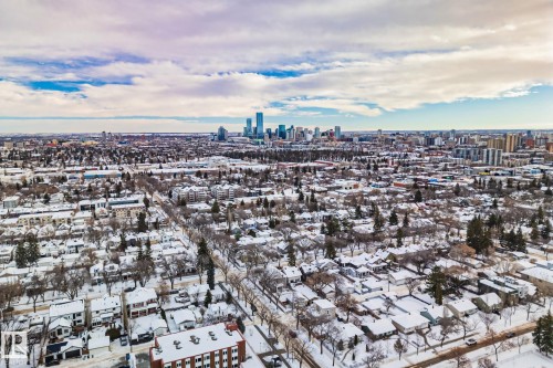 This expansive aerial view showcases a vibrant urban landscape featuring a mix of residential and commercial properties - 116 11033 127 Street, Edmonton, AB - Outdoor With View