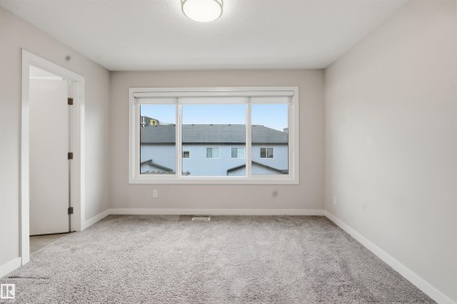 This room features clean, light-colored walls and a neutral gray carpet - 40 1729 Keene Crescent, Edmonton, AB - Indoor Photo Showing Other Room