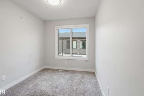 Room with neutral colored walls and carpet flooring, featuring a window and overhead lighting - 40 1729 Keene Crescent, Edmonton, AB - Indoor Photo Showing Other Room