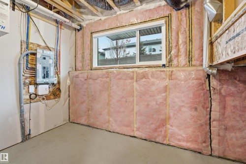The property features a utility area with an electrical panel and exposed wiring, a window, and insulated walls - 40 1729 Keene Crescent, Edmonton, AB - Indoor Photo Showing Basement
