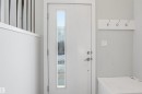 Entryway featuring a white door with a vertical window, light grey walls, and a white coat rack with four hooks - 40 1729 Keene Crescent, Edmonton, AB  - Indoor Photo Showing Other Room 