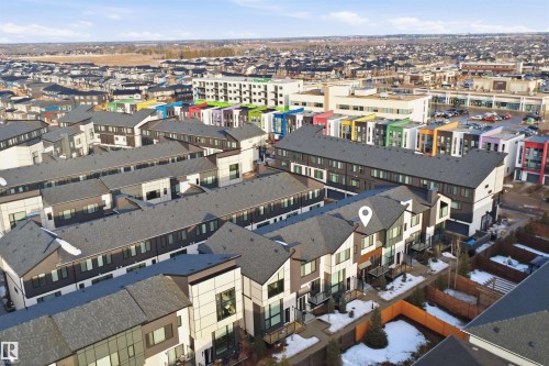 Aerial view of the neighborhood showcasing townhomes with dark grey roofs and modern facades - 40 1729 Keene Crescent, Edmonton, AB - Outdoor With View