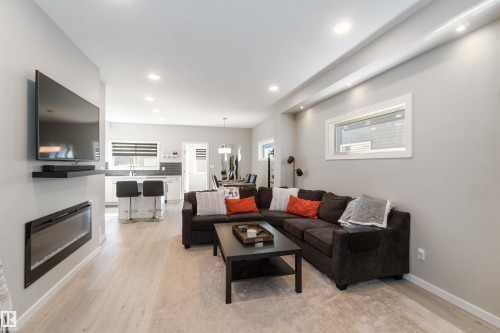 Living space featuring light-colored flooring, recessed lighting, and an electric fireplace - 29 Gambel Loop, Spruce Grove, AB - Indoor Photo Showing Living Room With Fireplace