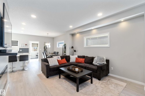 Well-lit living area featuring light-colored flooring, recessed lighting, and a window providing natural light - 29 Gambel Loop, Spruce Grove, AB - Indoor Photo Showing Living Room