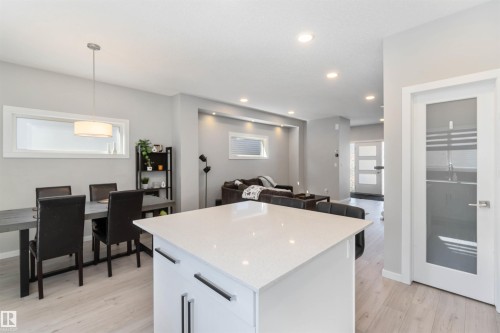 Open concept living space featuring recessed lighting, light-toned flooring, and an island with a light-colored countertop - 29 Gambel Loop, Spruce Grove, AB - Indoor Photo Showing Other Room