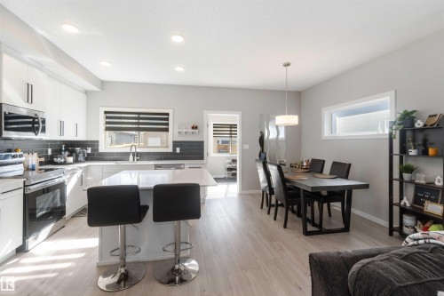 The property features a bright kitchen and dining area with light-colored flooring throughout - 29 Gambel Loop, Spruce Grove, AB - Indoor