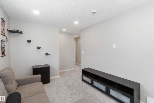 This room features light grey walls and light-colored carpet, creating a bright and neutral space - 29 Gambel Loop, Spruce Grove, AB - Indoor